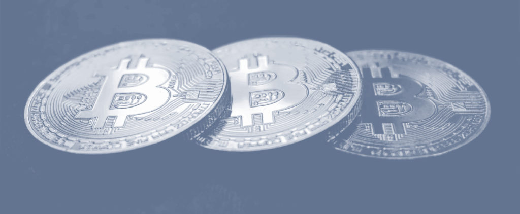 An image of 3 bitcoins in a line